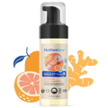 Bottle of Motherlove Baby and All Soap - Ginger Grapefruit with illustrated fruit behind the bottle