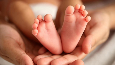 Parenting holding baby's feet
