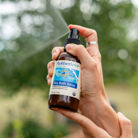 Sitz Bath Spray being sprayed into the sun in a hand