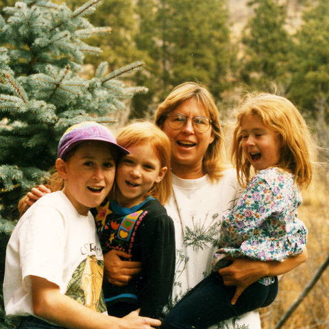 Founder, Kathryn Higgins, with her 3 daughters when they were children. Standing in nature. 