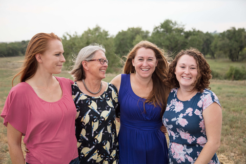 Founder, Kathryn Higgins, with her 3 daughters standing in nature. 