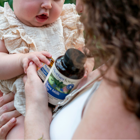 Mom and baby holding two Motherlove products, Nipple Cream and More Milk Plus