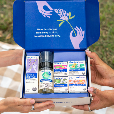 Box of Motherlove products being handed from one person to another