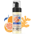 Bottle of Motherlove Baby and All Soap - Ginger Grapefruit with illustrated fruit behind the bottle